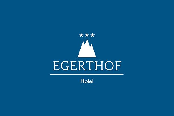 Logo of Hotel Egerthof with mountains and stars on a blue background.