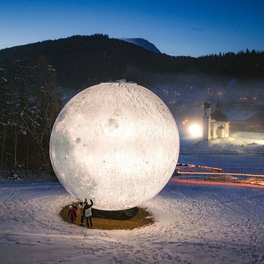 Illuminated moon sphere in snowy Region Seefeld evening.