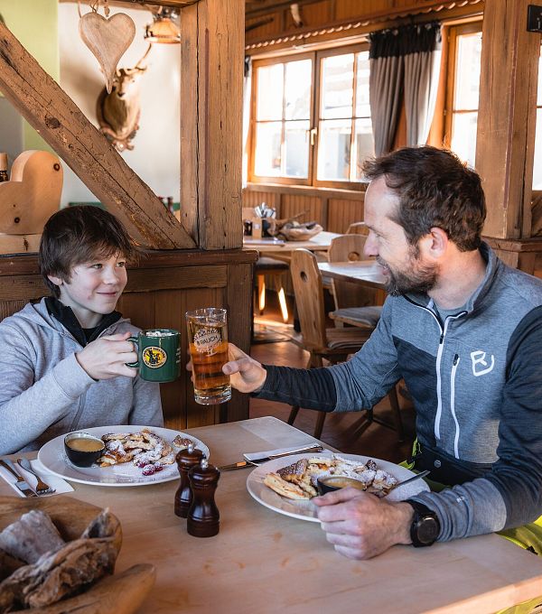 Einkehr beim Skifahren - Vater und Sohn auf der Hütte