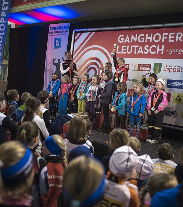 Children on stage at the Ganghoferlauf event in Leutasch, celebrating in front of an audience.