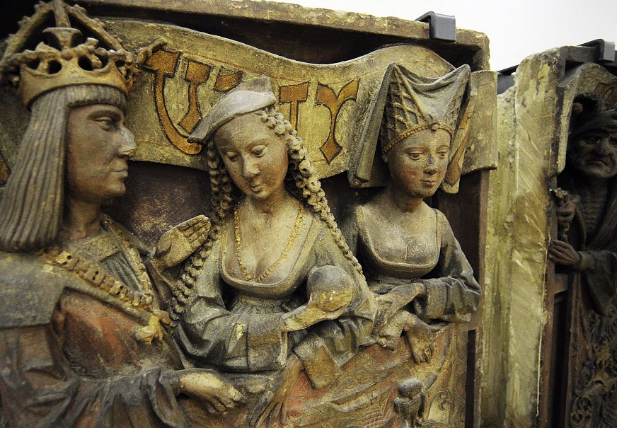 Medieval relief sculpture depicting three elegantly dressed women.