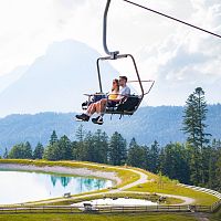 Auffahrt auf den Gschwandkopf mit dem Sessellift - Paar vor Hohe Munde und Speichersee