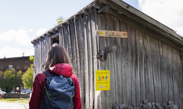 Hofladenrunde Leutasch - Frau läuft auf Straße vor Wirtseppelerhof