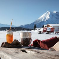 Polis Hütte im Winter_Getränke auf Holztische mit Blick auf Hohe Munde